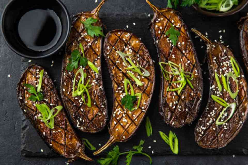 Roasted miso aubergine garnished with fresh herbs