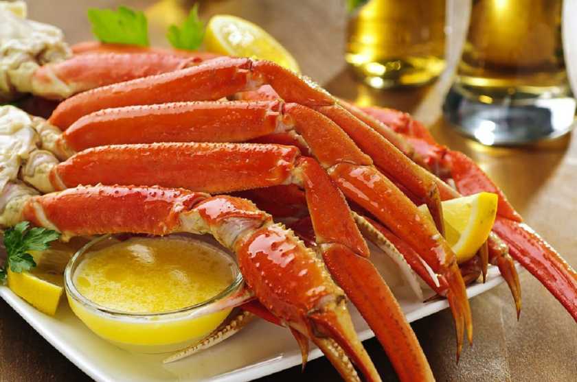 Grilled  with a garlic butter marinade, crabs claws featuring grill marks.