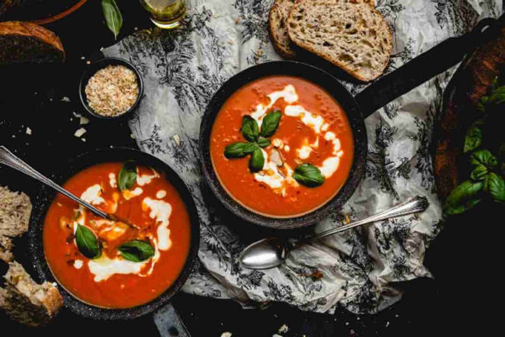 Tomato soup served with crusty bread.