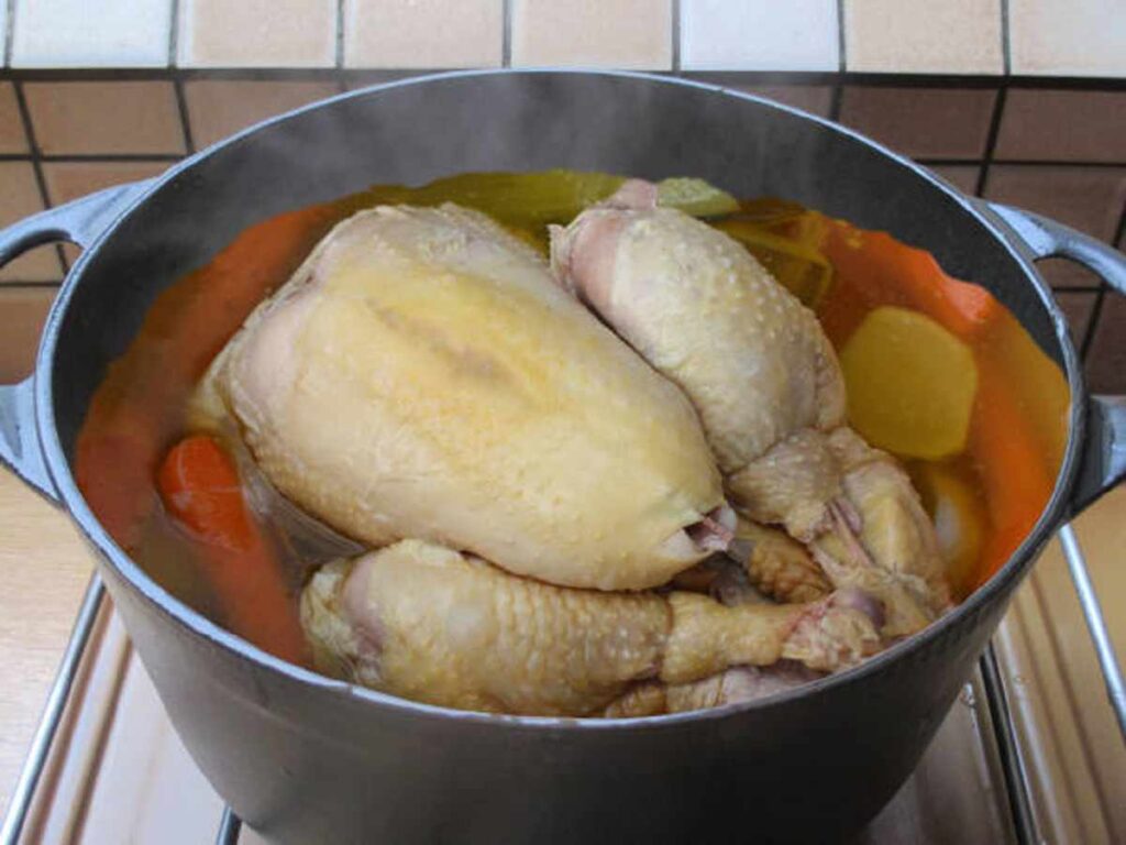 Cooking pot with simmering Cock Soup